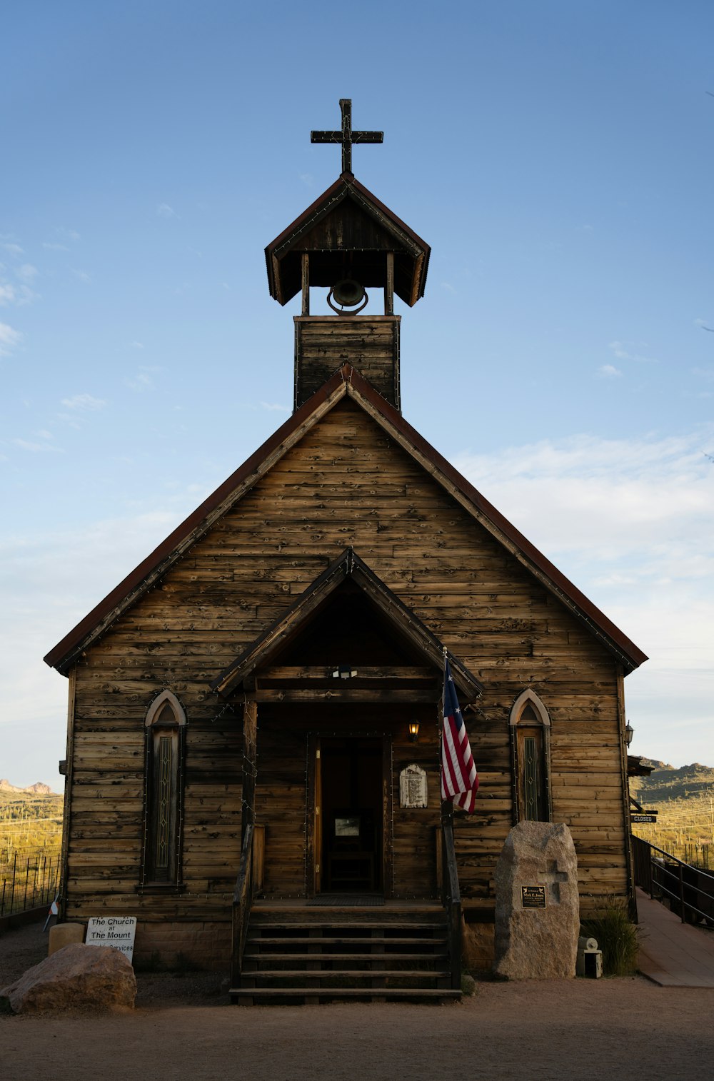 an old wooden church with a cross on top