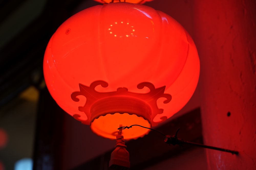 a red light hanging from the side of a building