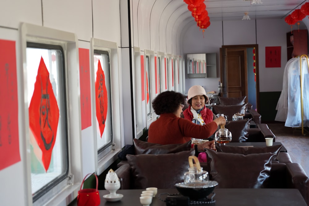 a couple of people sitting at a table in a room