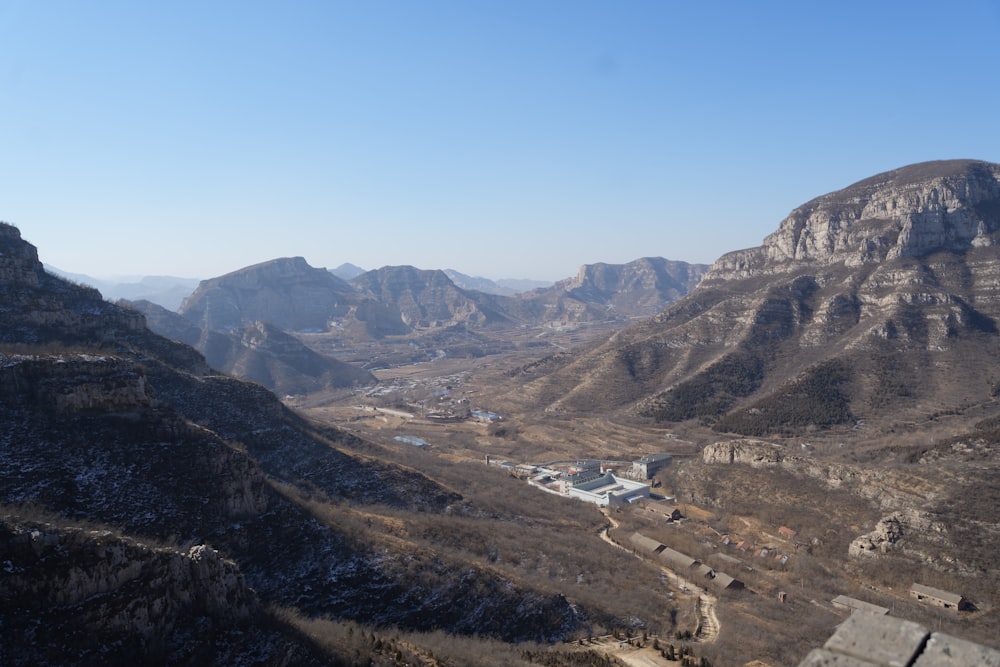 a view of a valley with mountains in the background