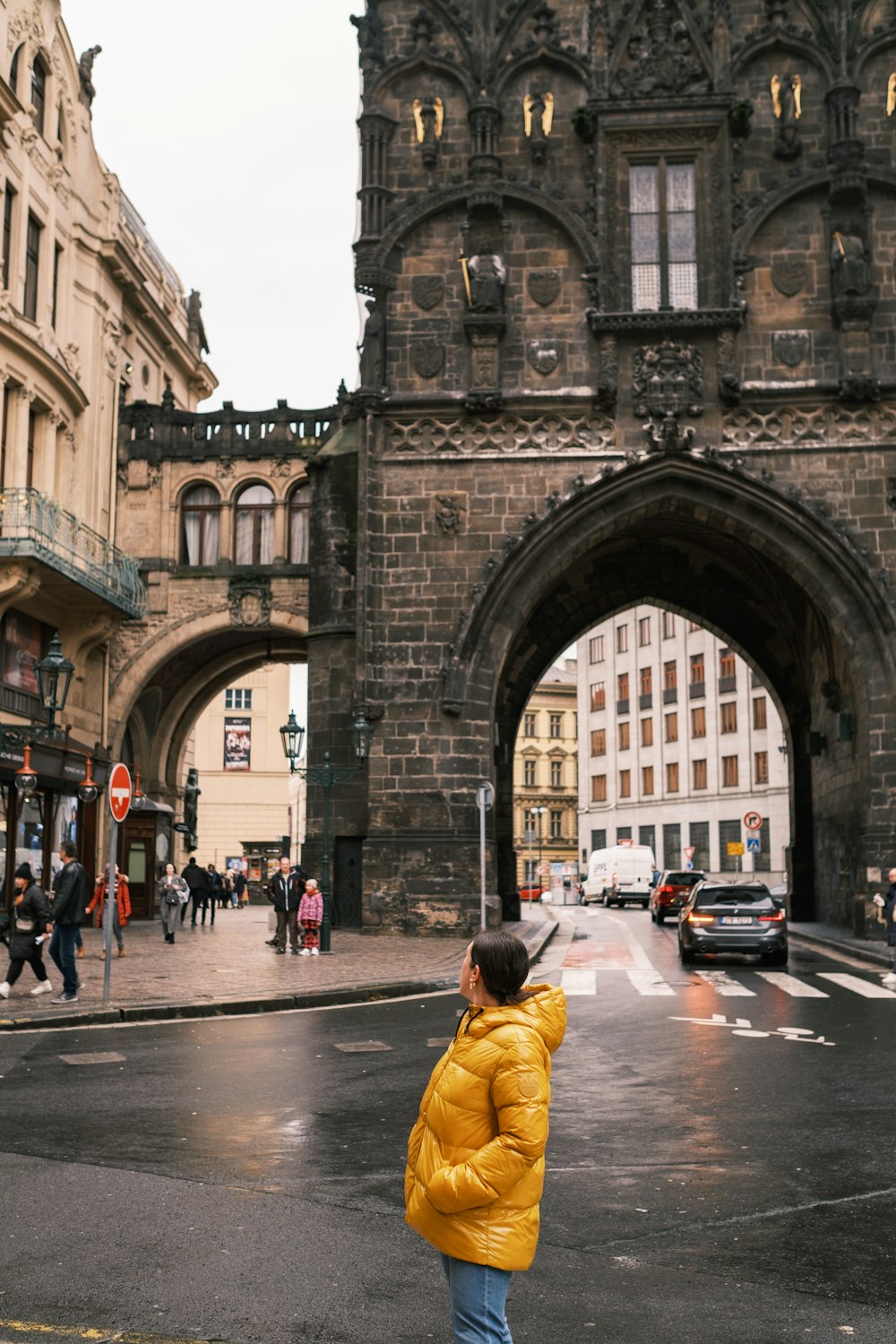 a person in a yellow jacket is standing in the street