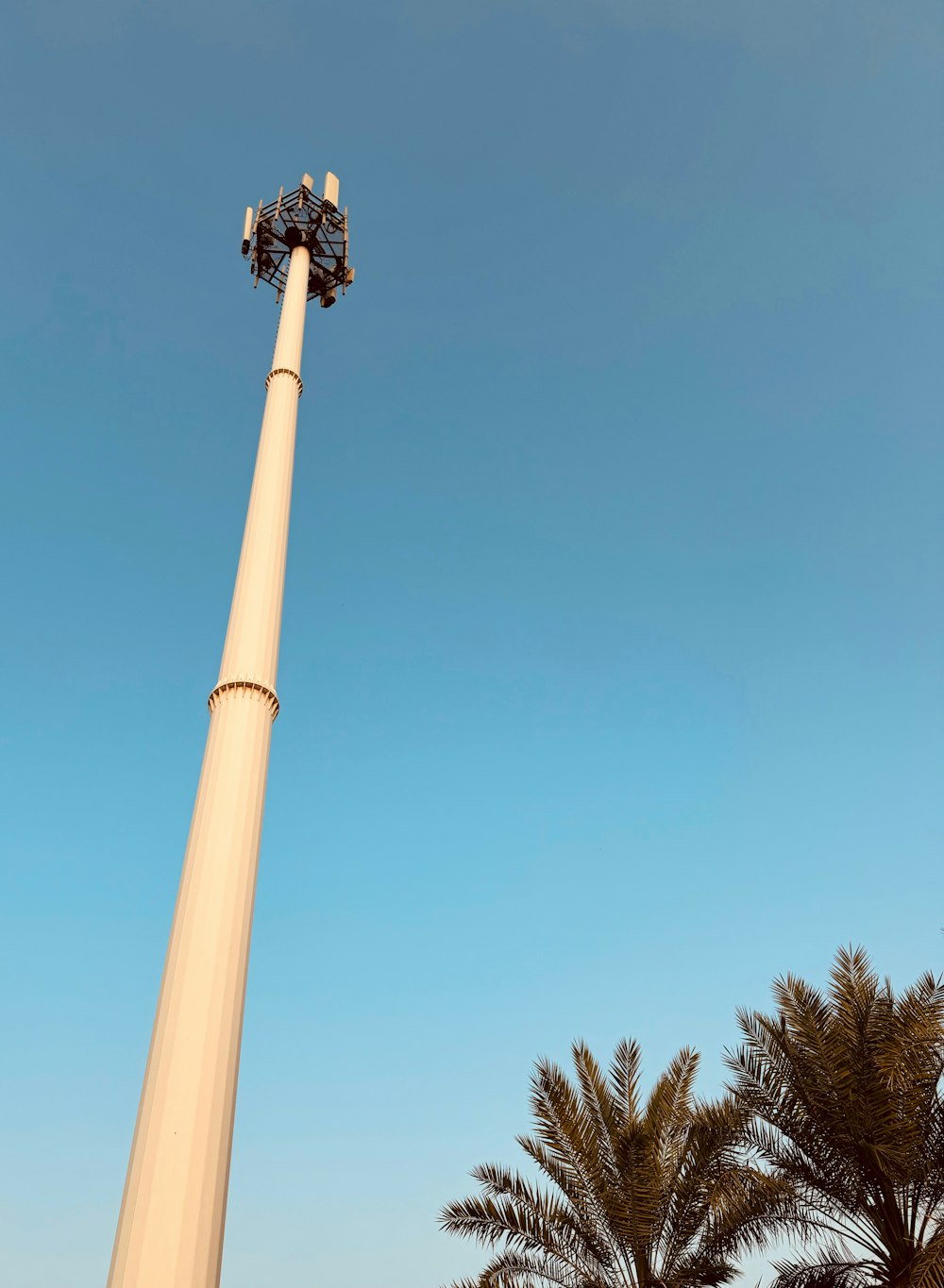 a tall light pole with a sky background