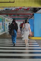 a couple of people that are walking down a street
