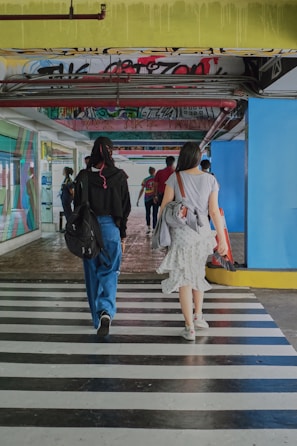 a couple of people that are walking down a street