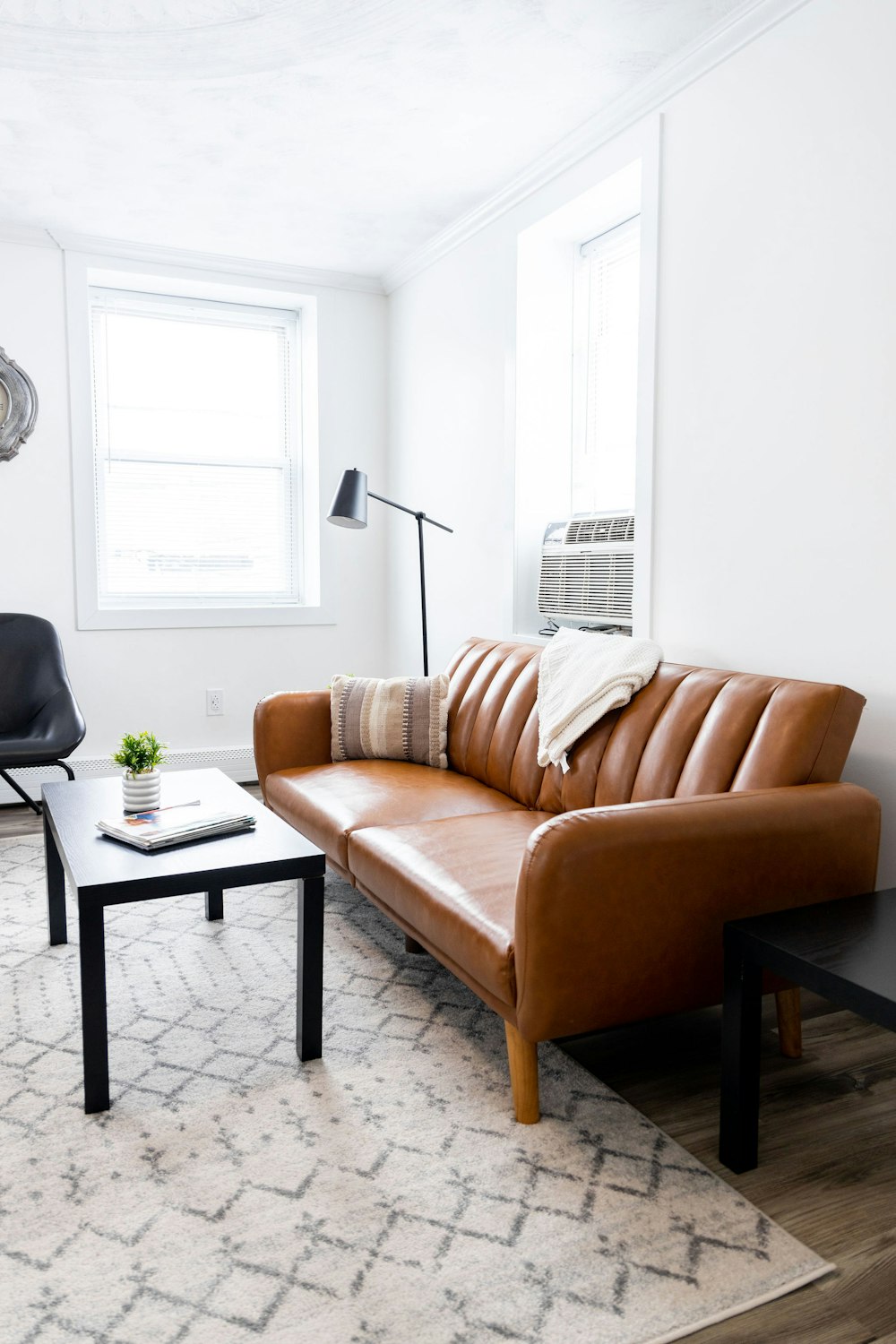 a living room with a leather couch and a coffee table