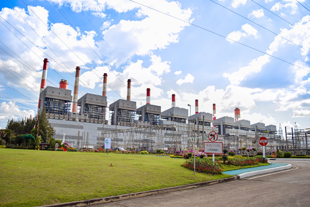 a factory with a lot of smoke stacks in the background