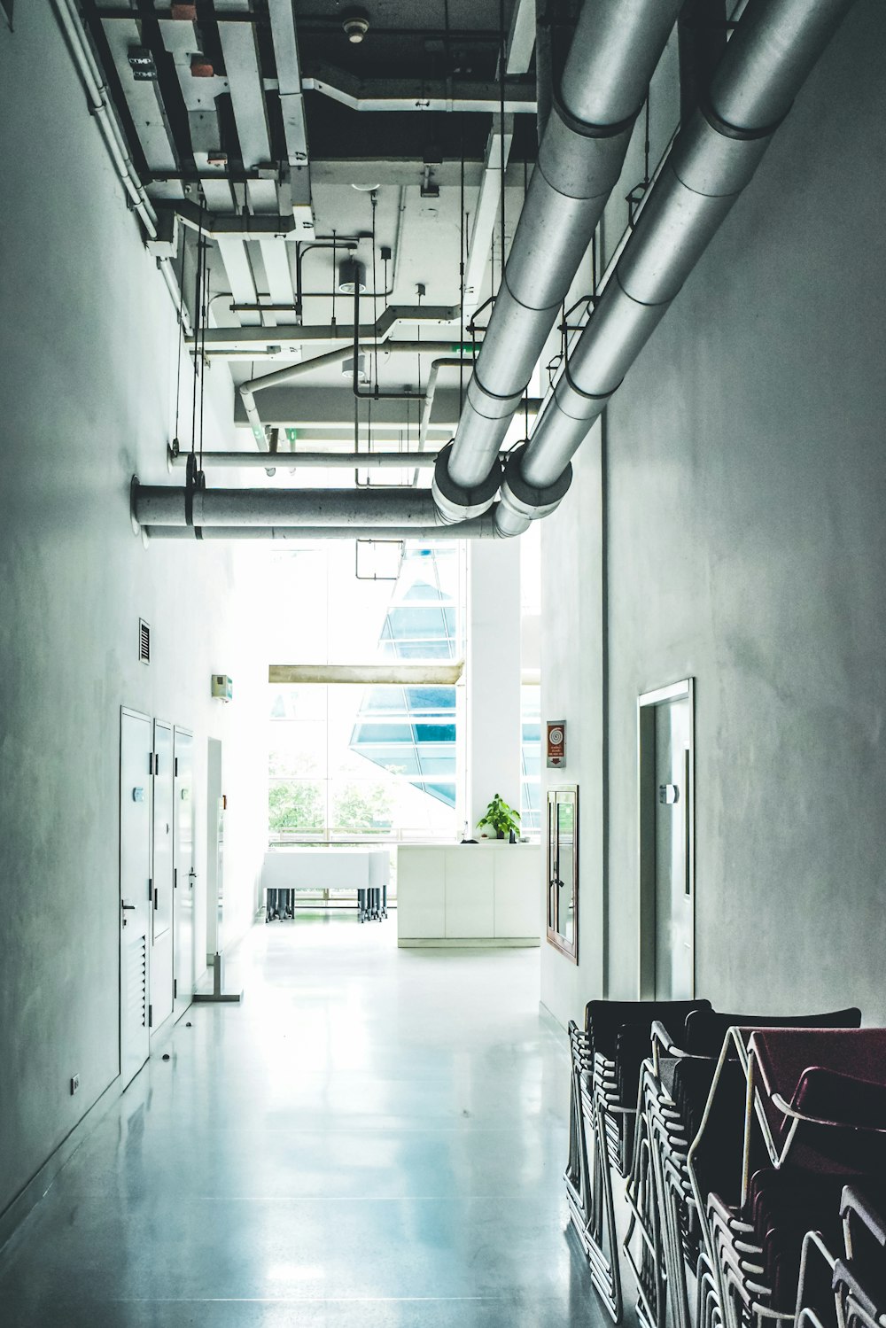 a long hallway with a bunch of chairs in it