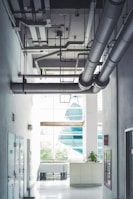 a room with a lot of pipes hanging from the ceiling