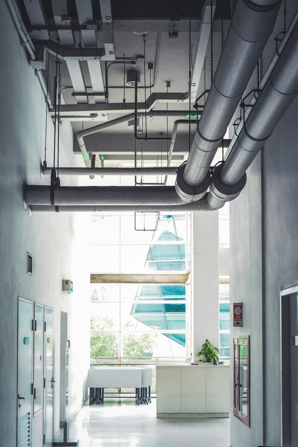 a room with a lot of pipes hanging from the ceiling