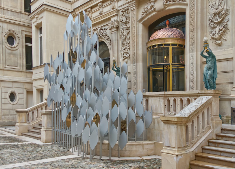 a building with a large metal sculpture in front of it