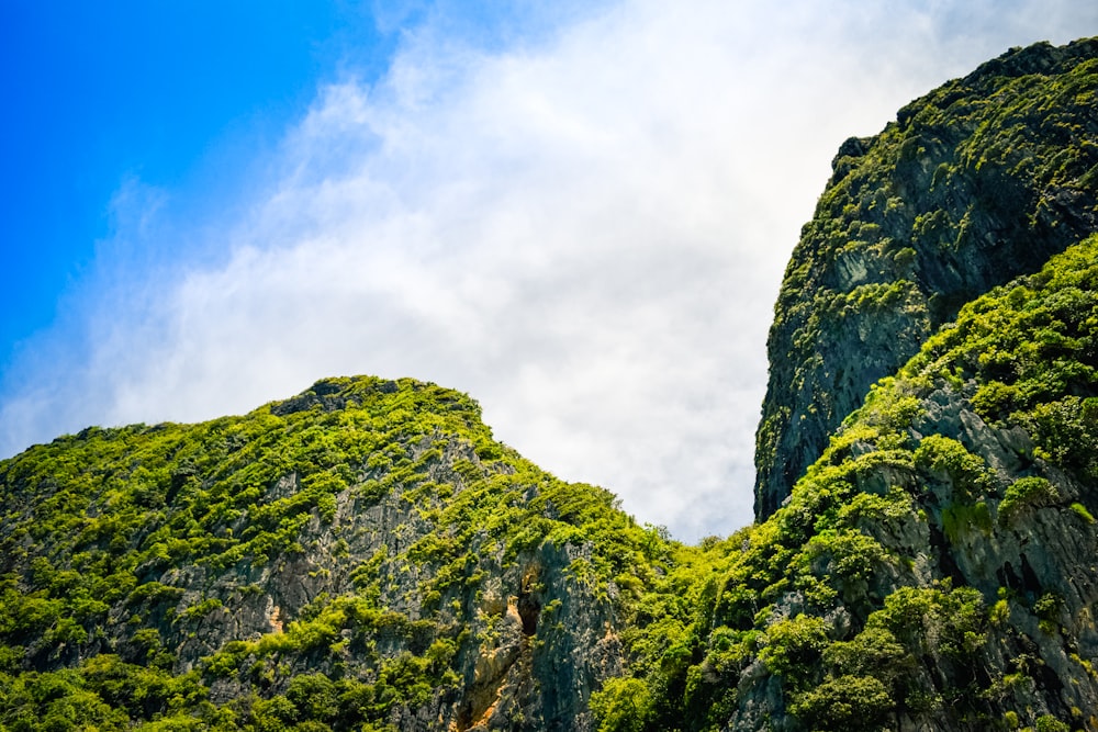 a very tall mountain covered in lush green vegetation