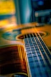 a close up of a guitar with a blurry background