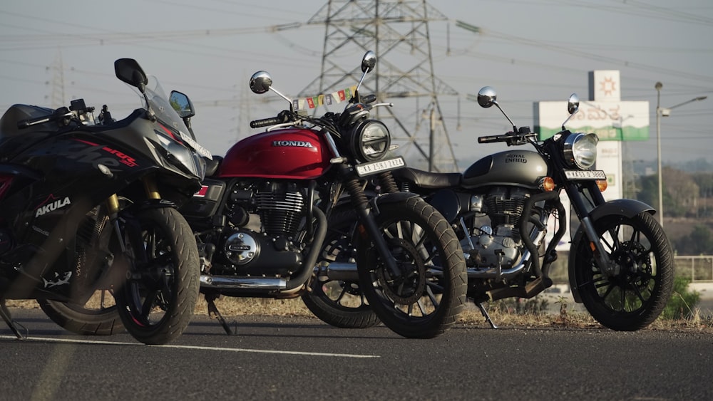 two motorcycles parked next to each other on the side of the road