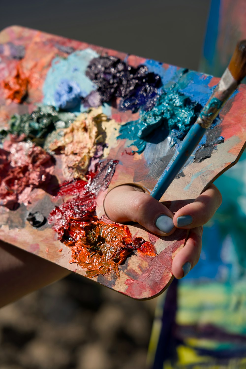 a person holding a paintbrush in their hand