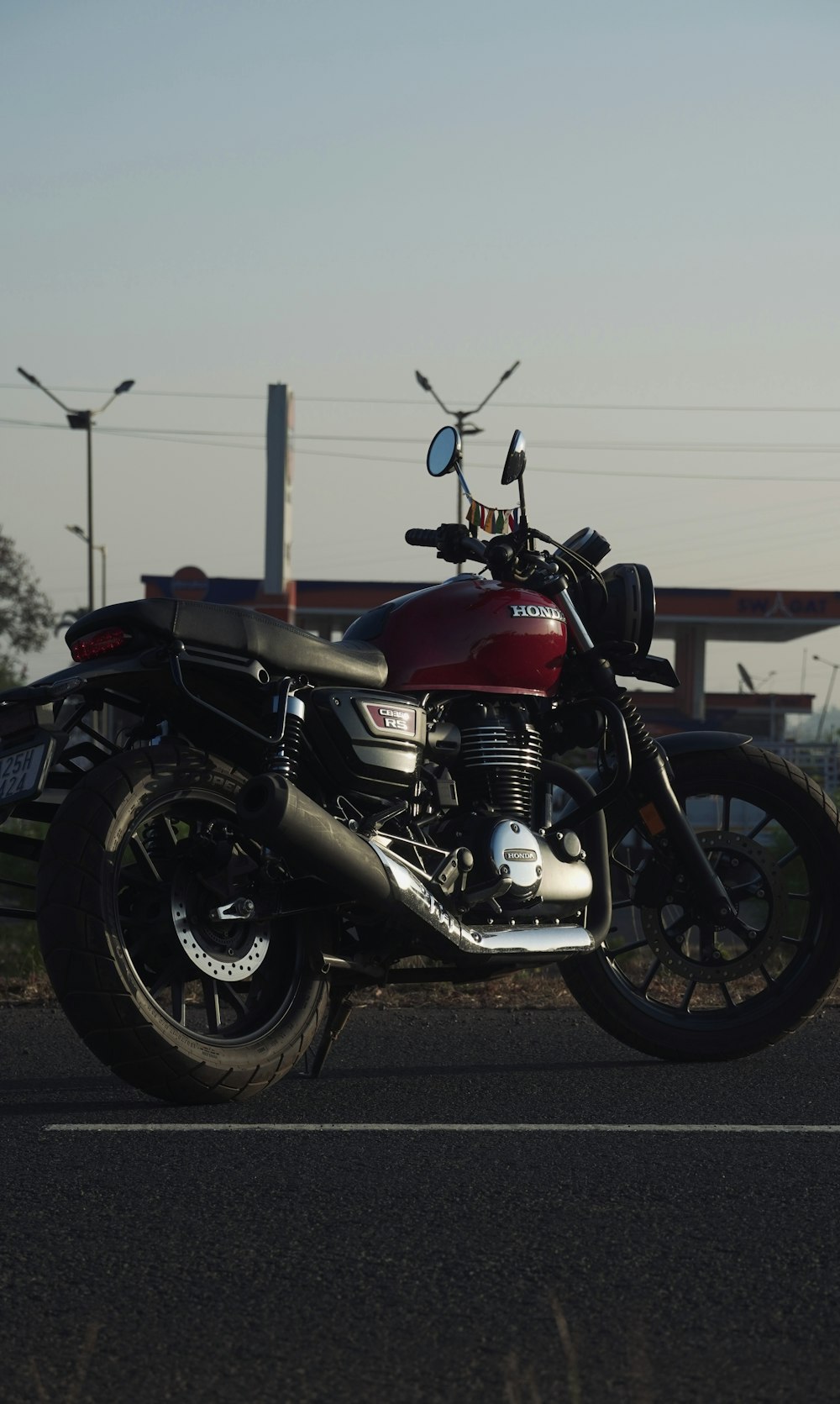 a red motorcycle parked on the side of the road