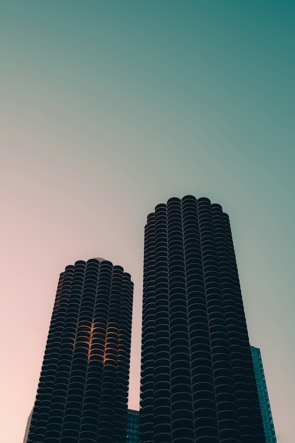 a couple of tall buildings sitting next to each other