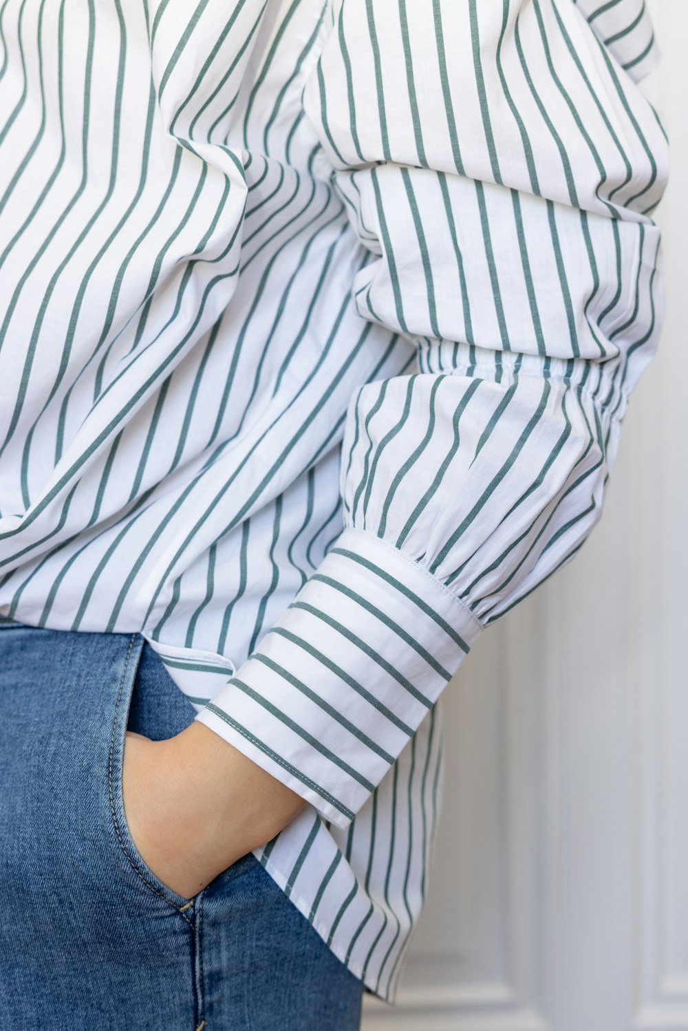 a close up of a person wearing a striped shirt