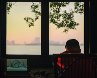 a man sitting in front of a laptop computer