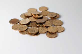 a pile of coins sitting on top of a white table