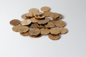 a pile of coins sitting on top of a white table