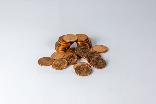a pile of coins sitting on top of a white table