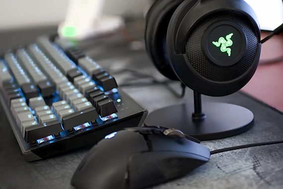Real gaming keyboard, mouse, and headset arranged on a desk