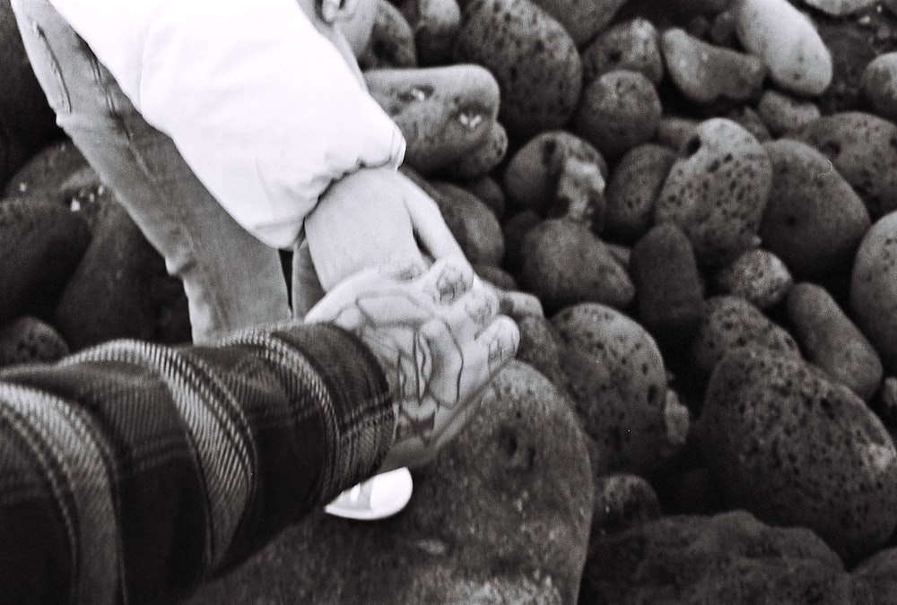 a person standing next to a pile of rocks