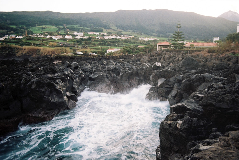 a large body of water near a rocky shore