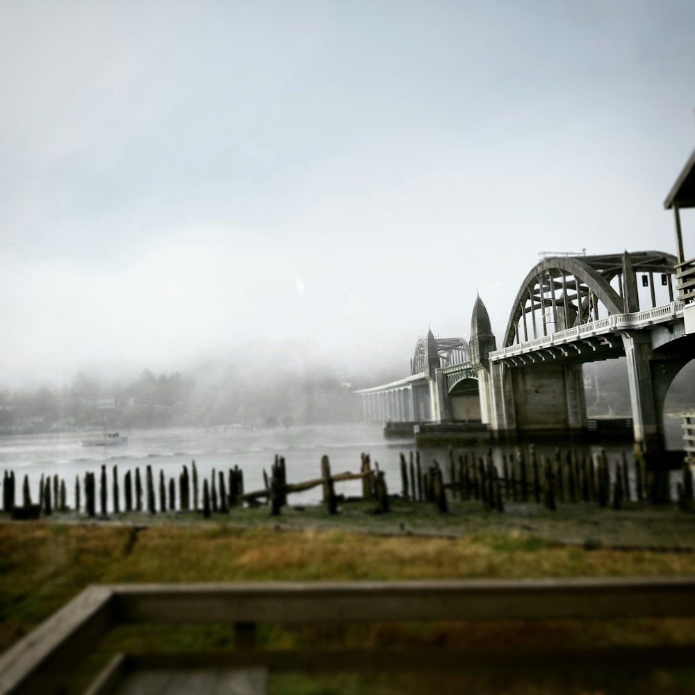 a bridge over a body of water on a foggy day