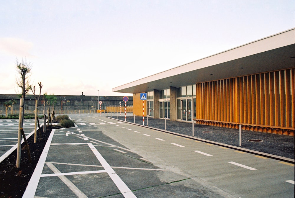 an empty parking lot with a building in the background