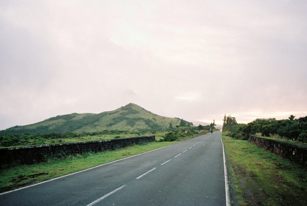 una strada vuota con una montagna sullo sfondo