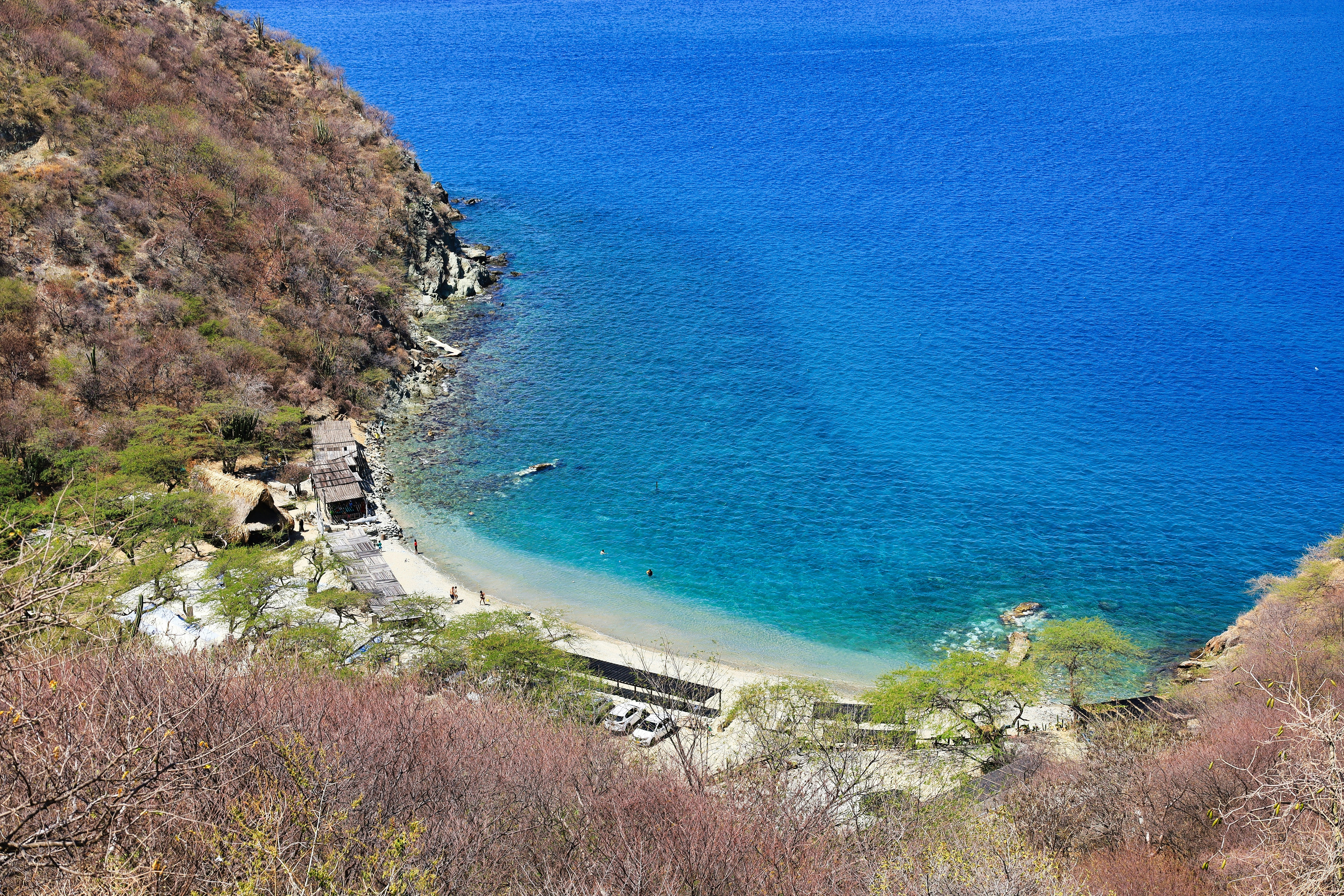 a body of water surrounded by a lush green hillside