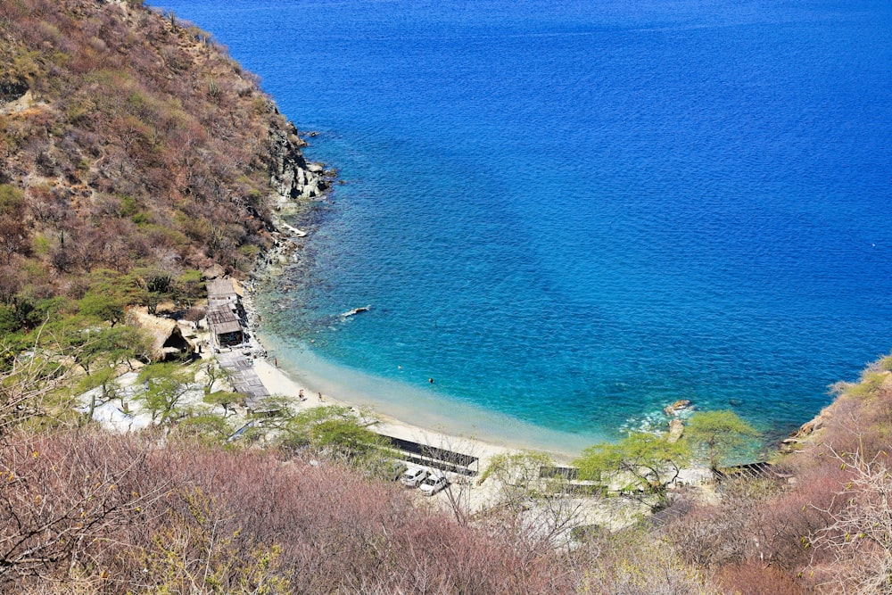 a body of water surrounded by a lush green hillside