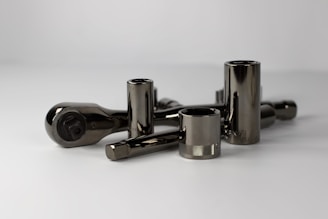 a group of metal objects on a white surface