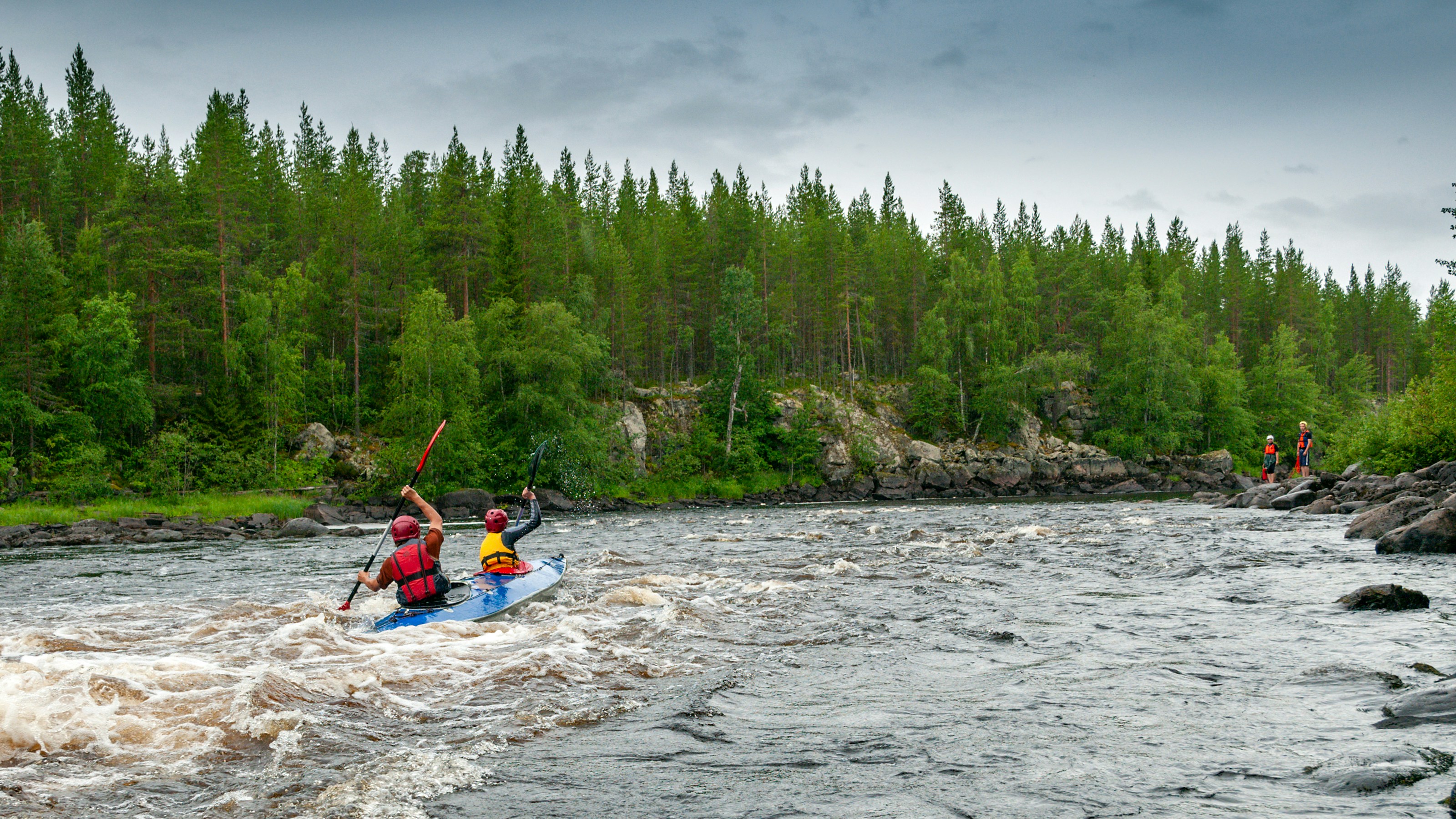 a group of people riding on top of a boat in a river