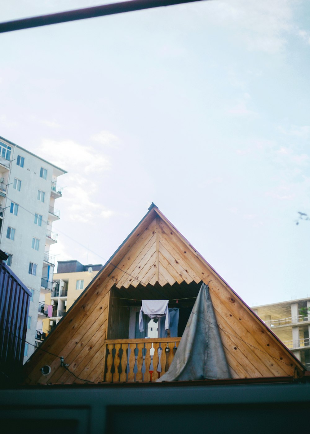 a small wooden structure with a roof and a balcony