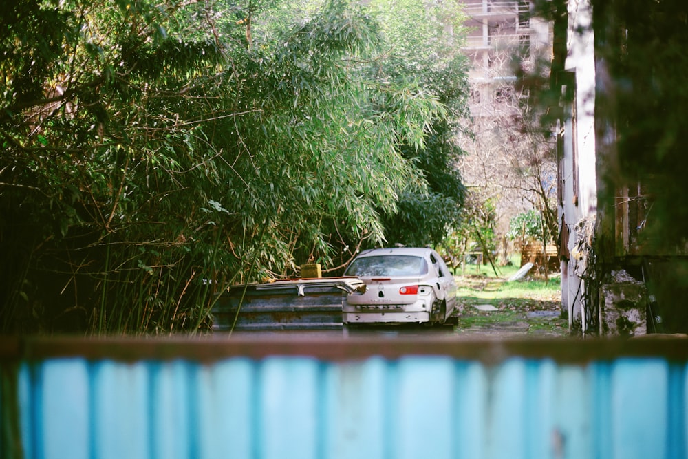 a car parked in front of a house in the woods