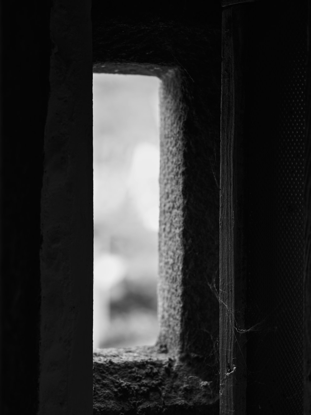 a black and white photo of a window in a building