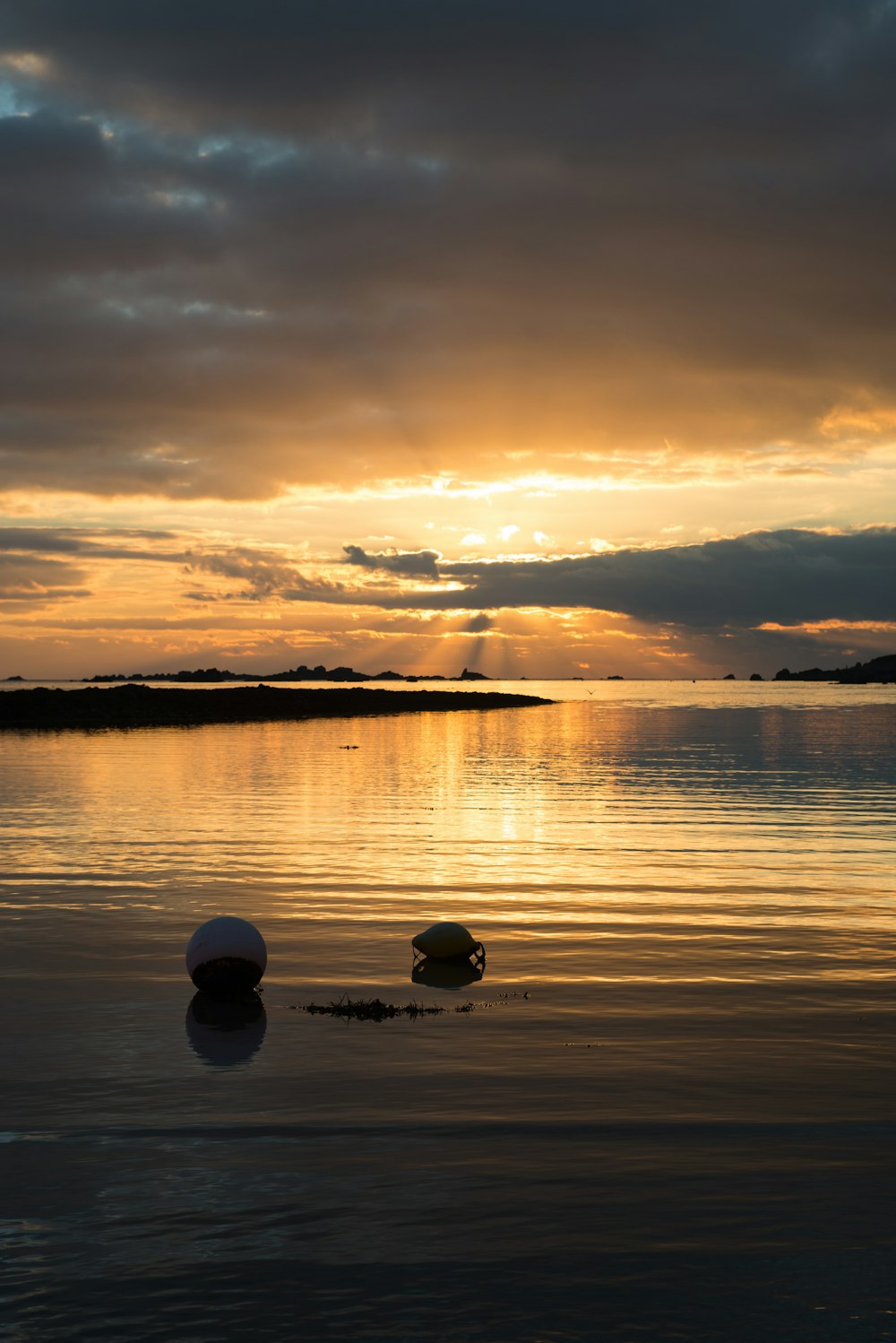 a couple of rocks sitting in the middle of a body of water