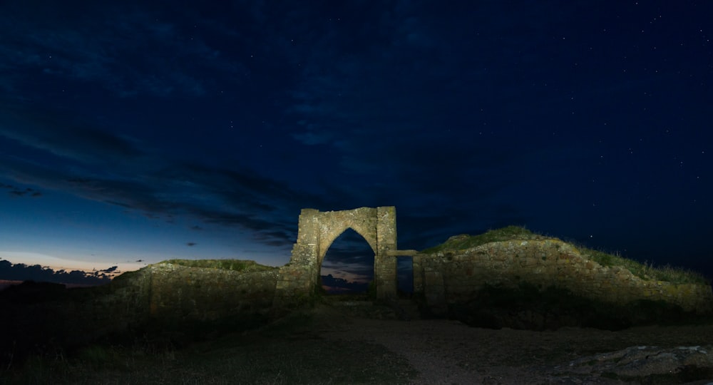 a night time scene of a stone structure