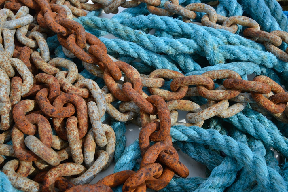 a pile of blue and orange ropes and chains