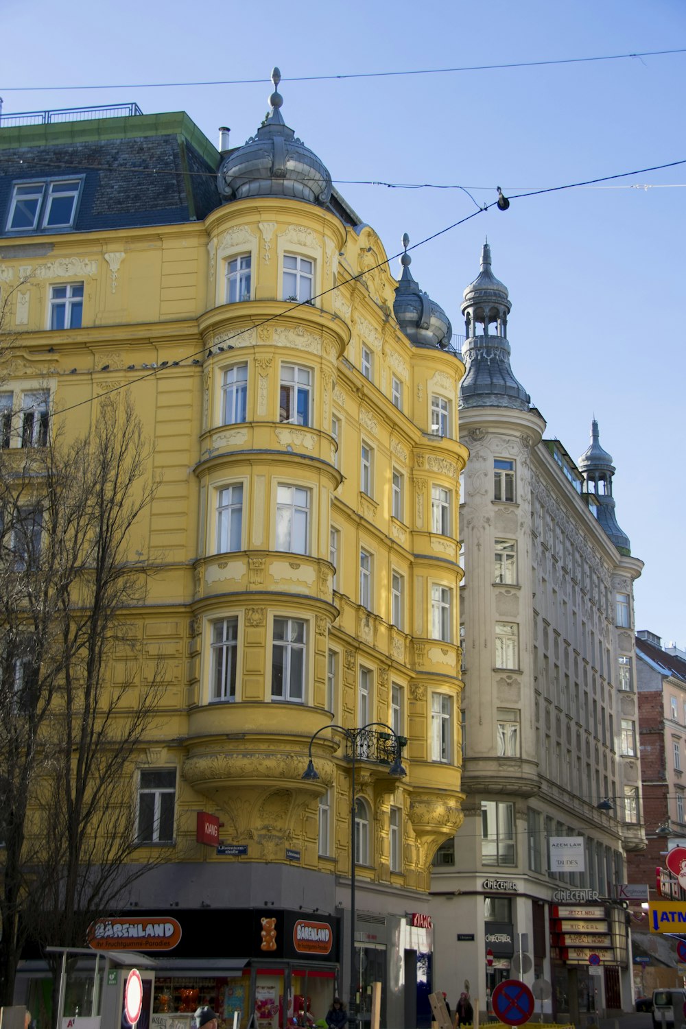 a large yellow building with a clock tower on top of it