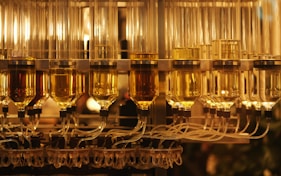 a bunch of wine glasses hanging from a rack