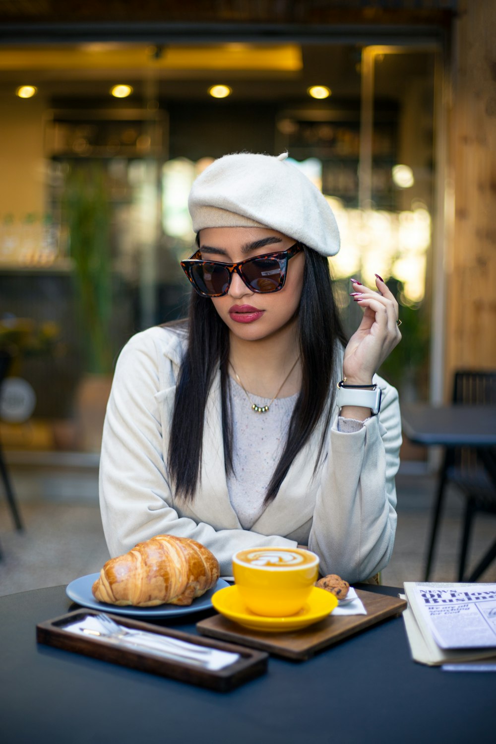 a woman sitting at a table with a plate of food