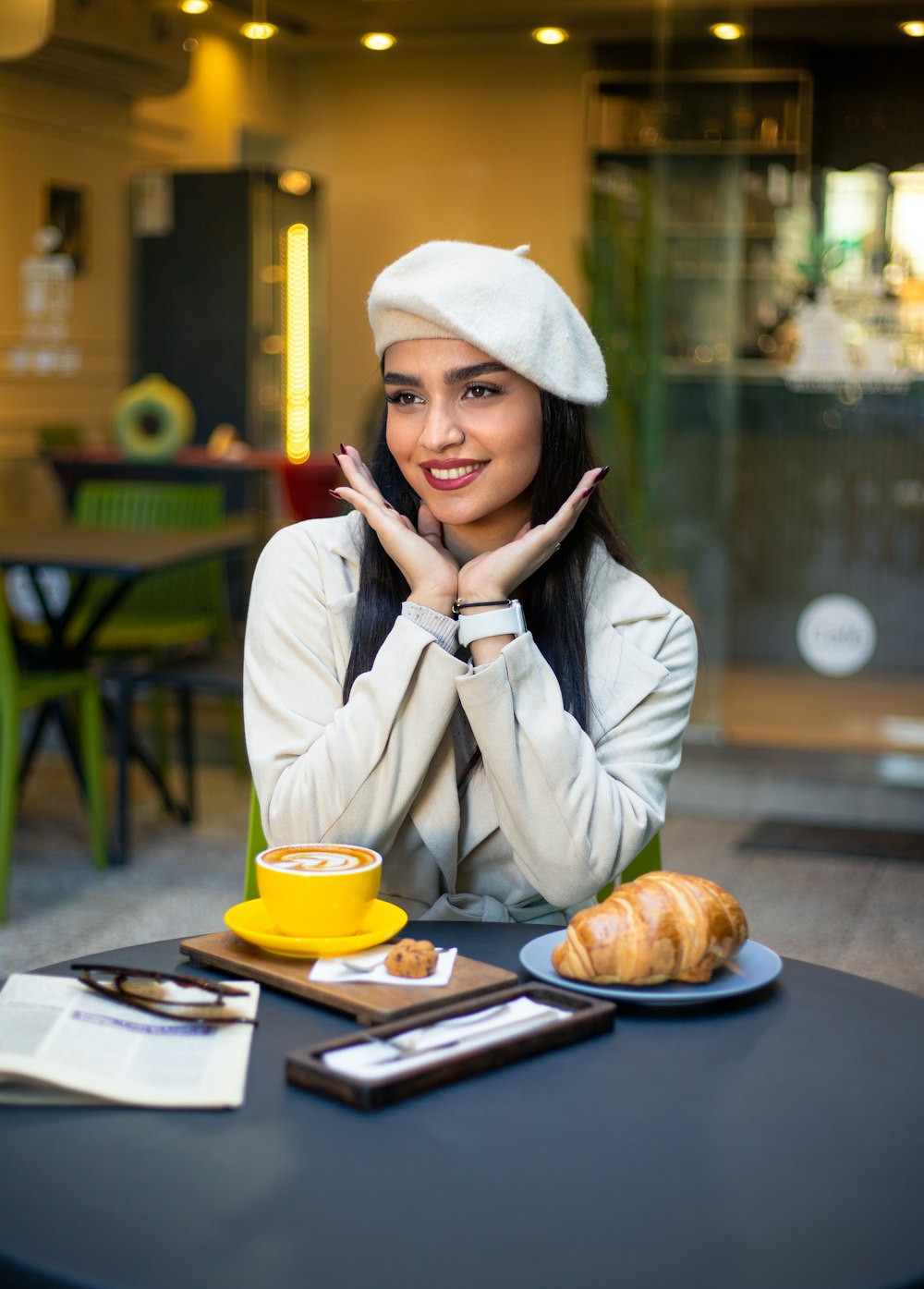 a woman sitting at a table with a plate of food