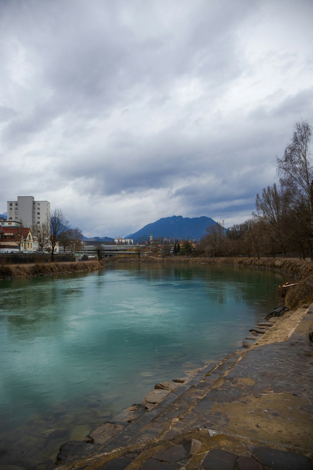 a body of water with buildings in the background