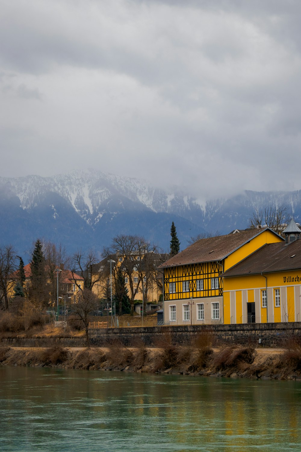 a yellow building sitting next to a body of water