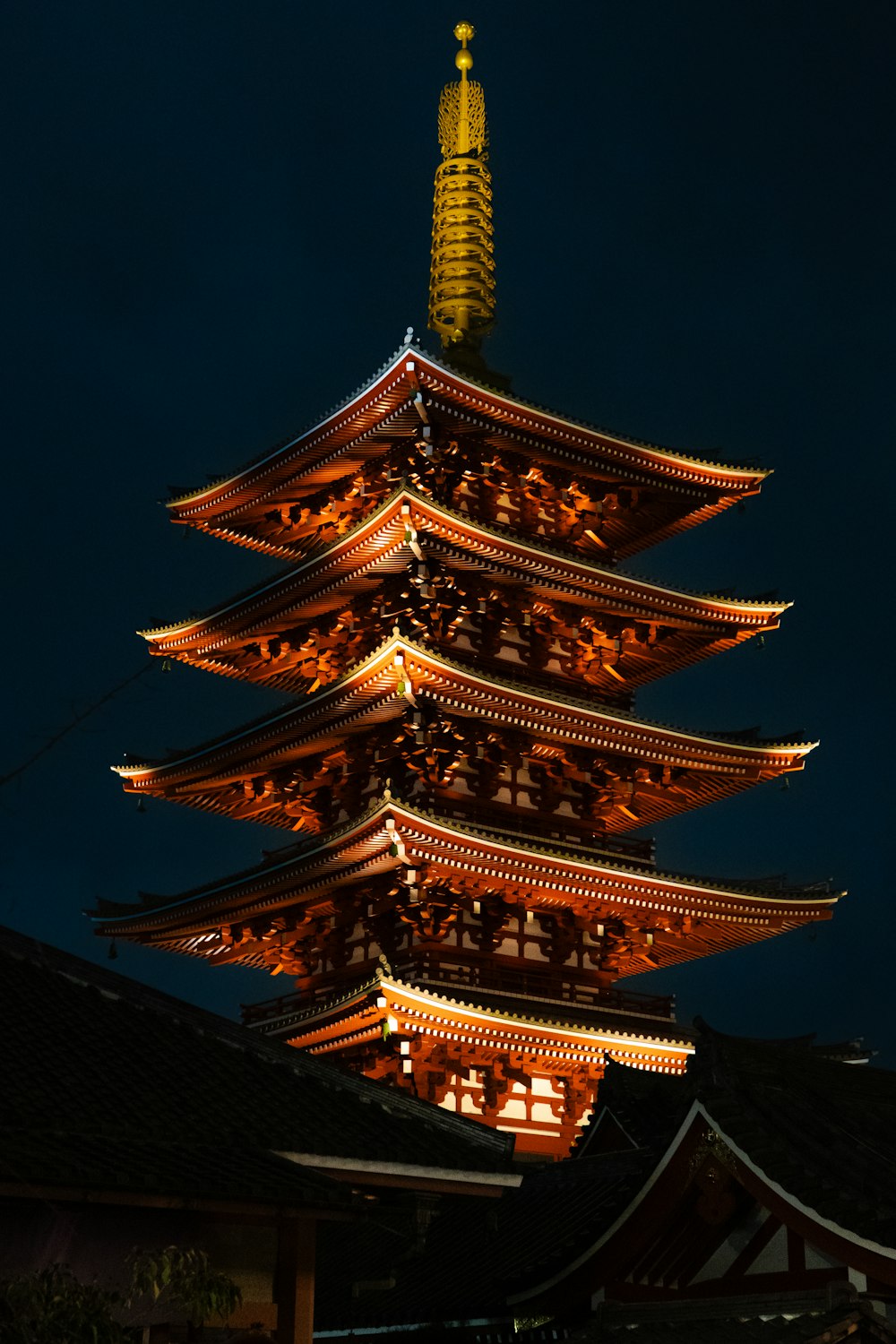 a tall building lit up at night with a sky background