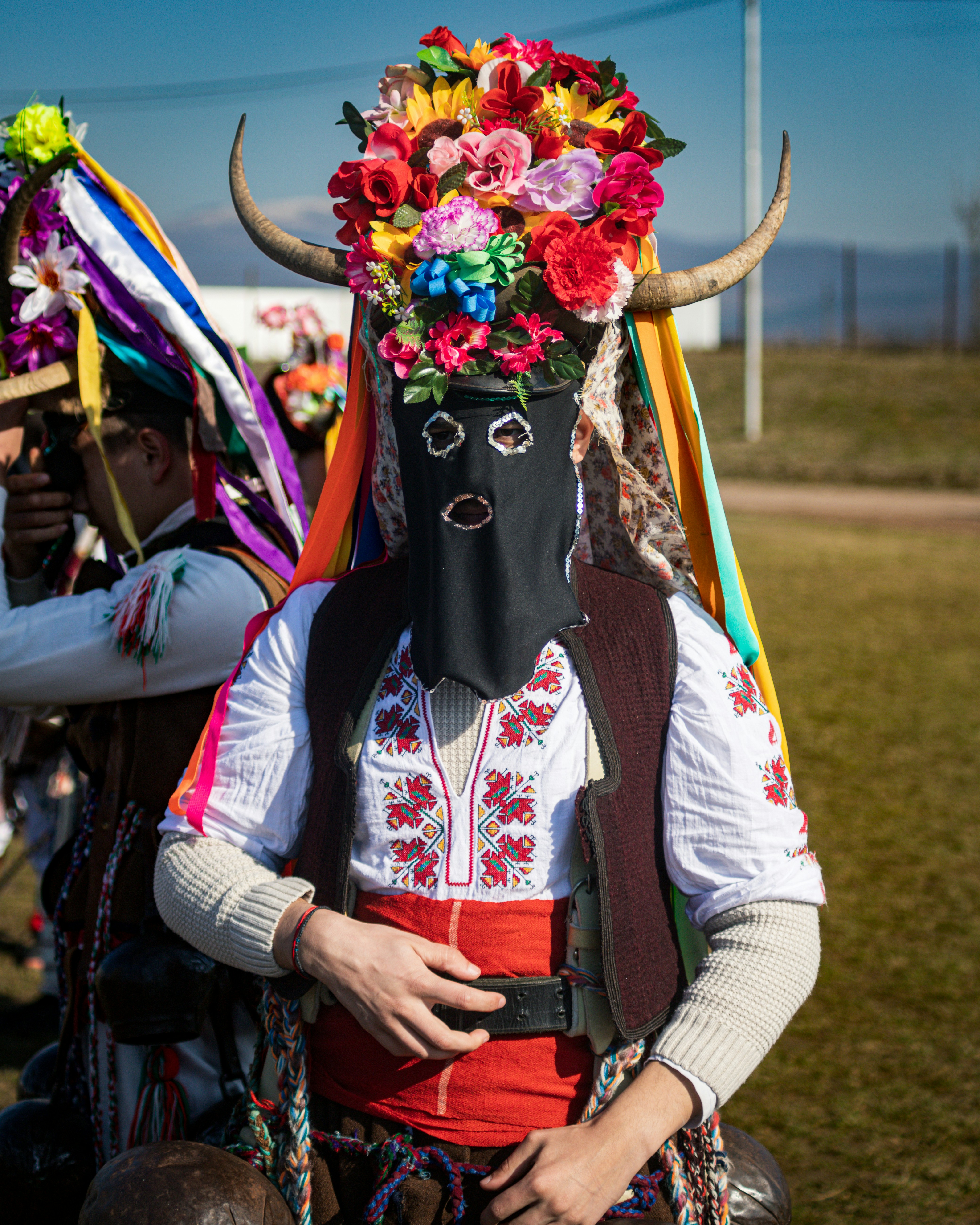 A woman wearing a mask with flowers on her head