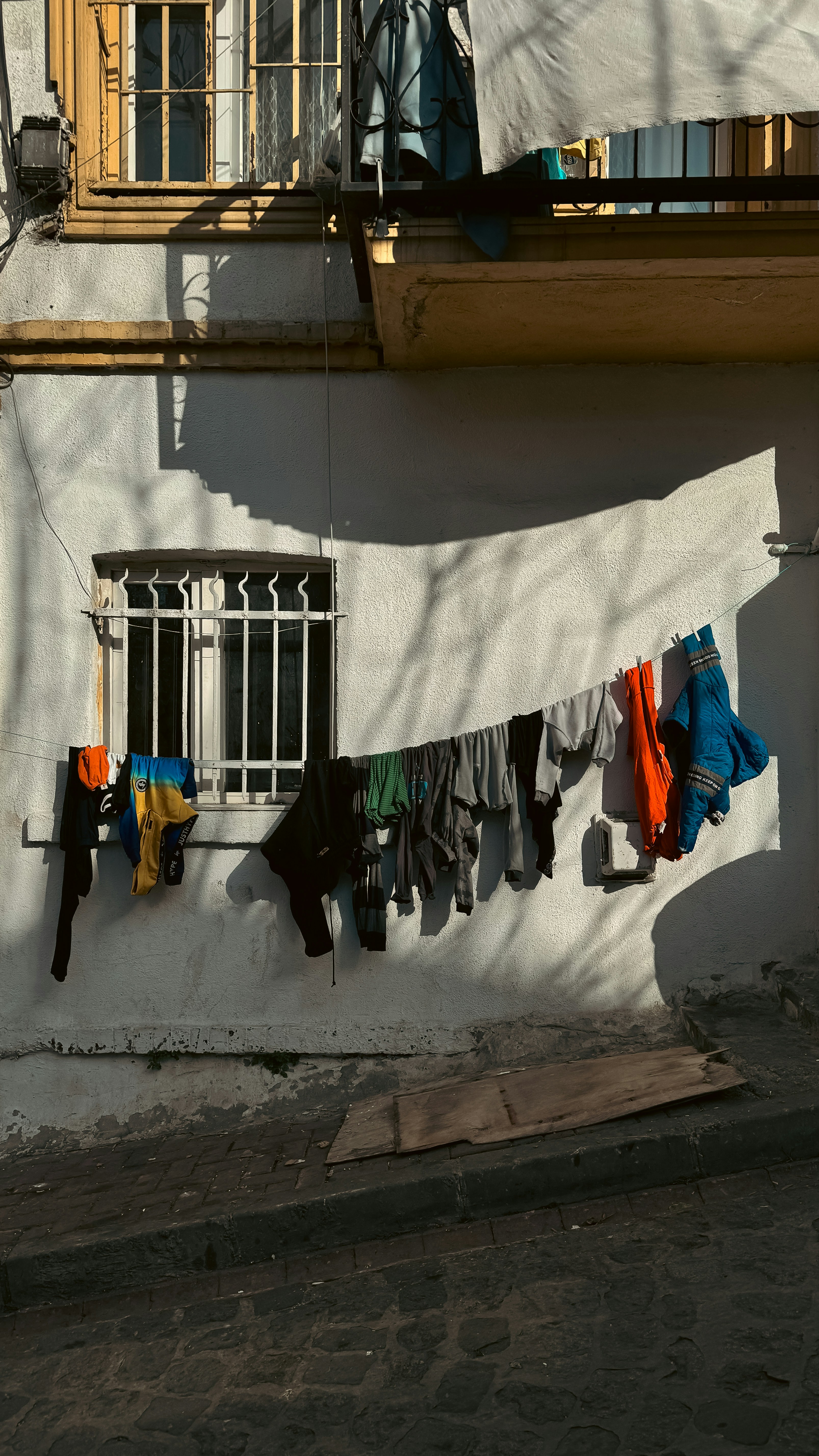 clothes hanging on a clothes line in front of a building